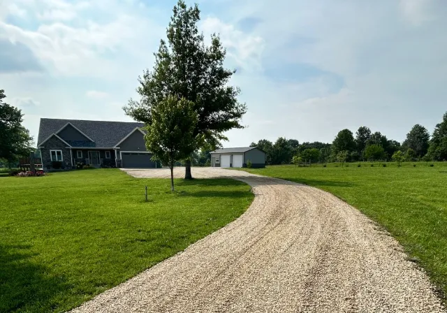 A modern dark gray house with an attached garage